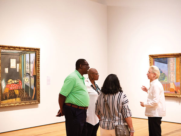 Curator leading a tour of a gallery