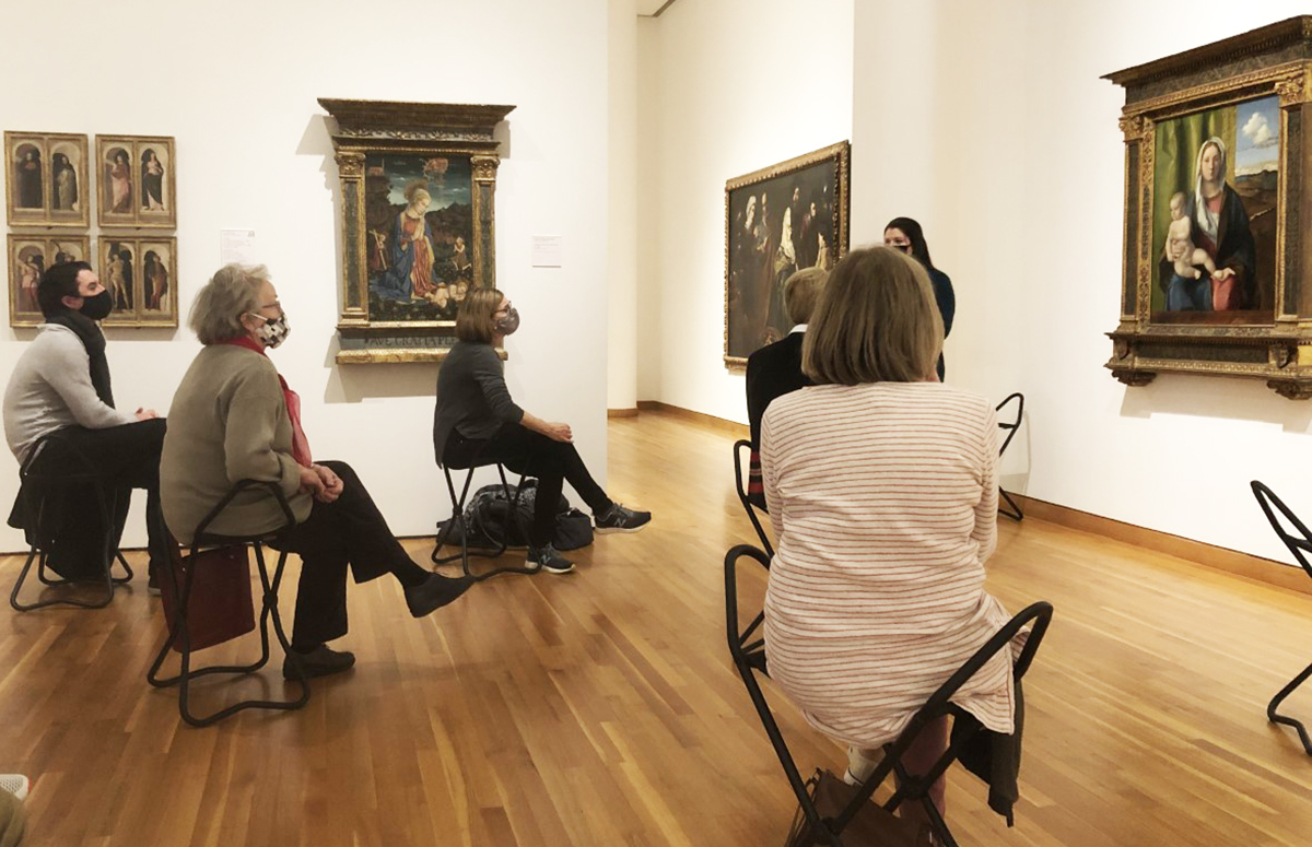 Visitors listen to a talk in the galleries