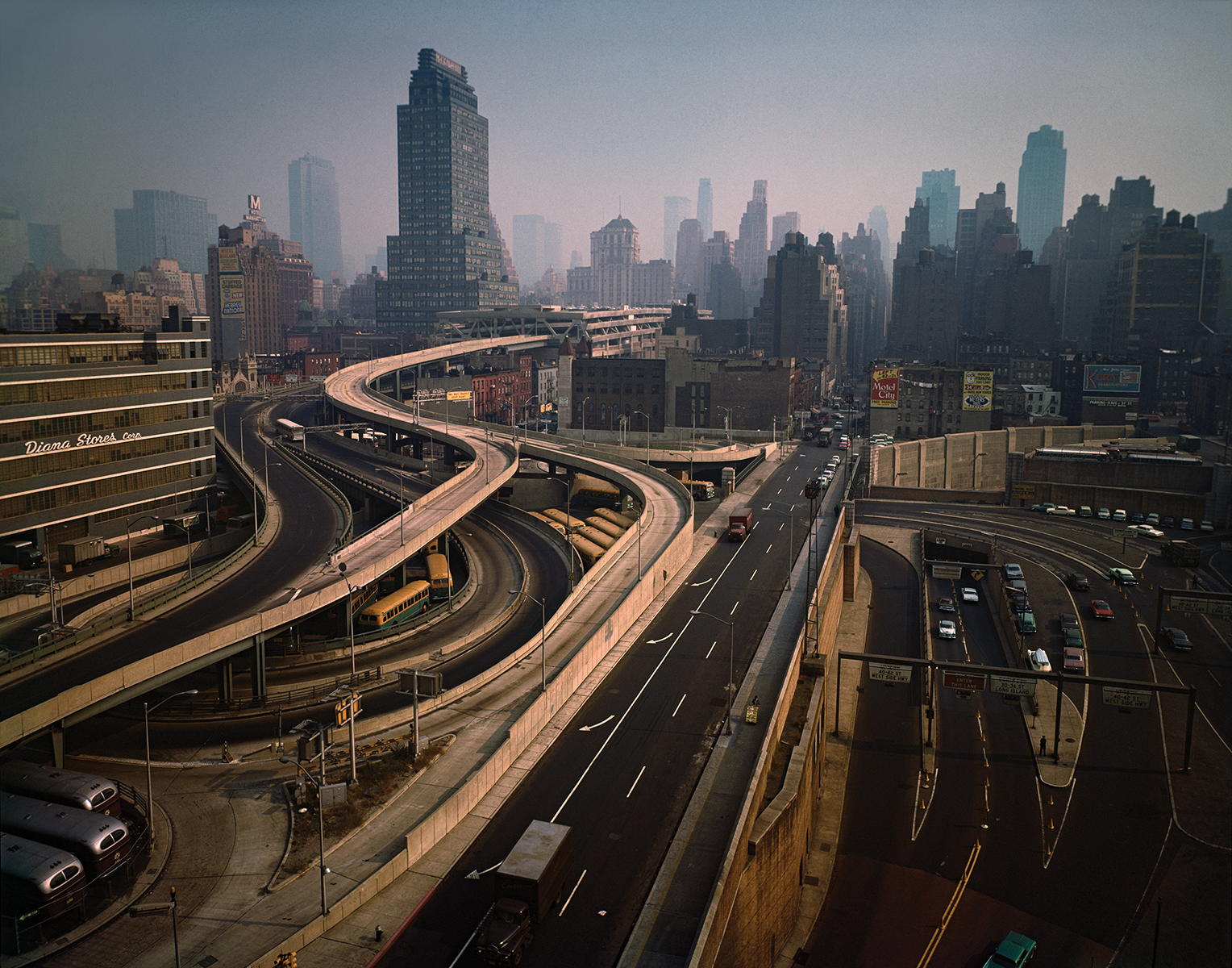 View of highways and interchanges with the Manhattan skyline beyond them.